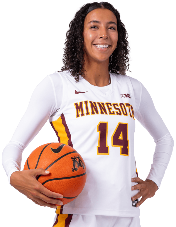 Female basketball player posing in uniform holding basketball