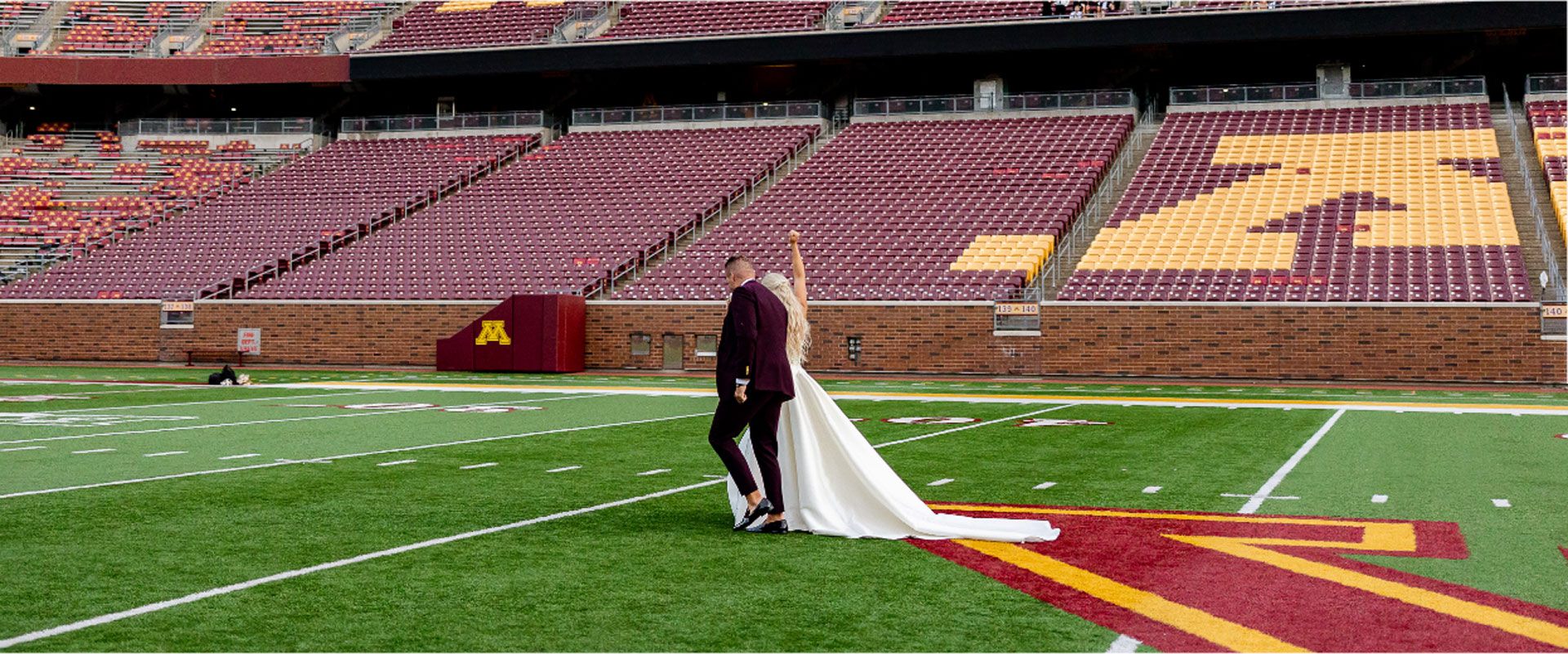 Bride and groom walking down field