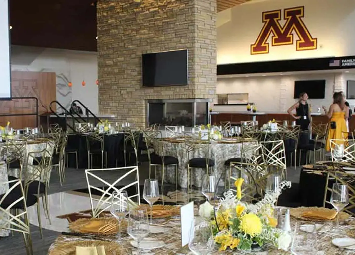 Stone fireplace dining hall with tables