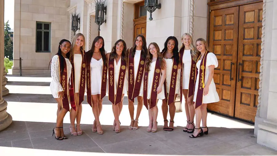 A group of women in white dresses posing for a photo