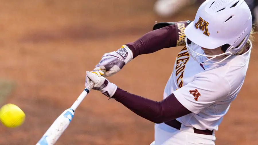 Softball player mid swing