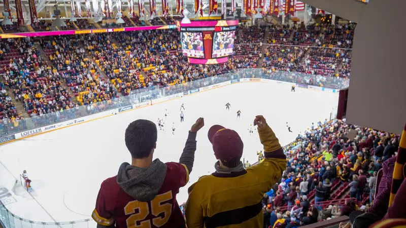 View of rink from behind fans with arms in the air