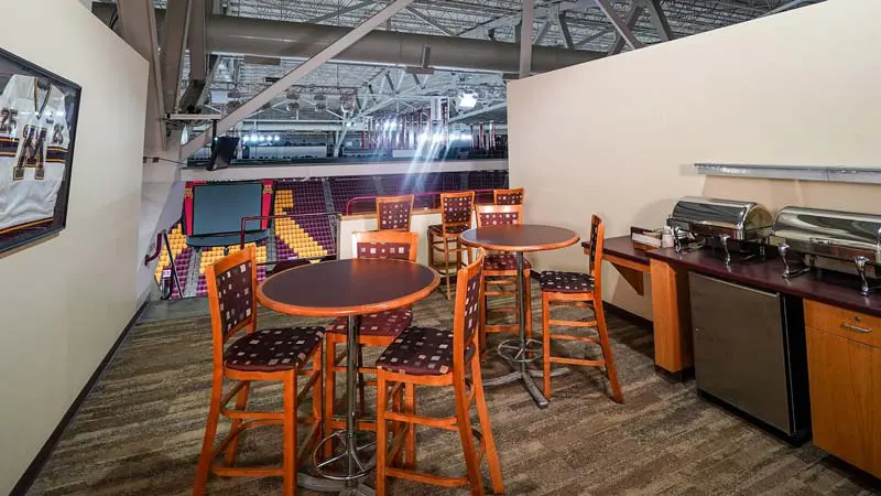 View of tables in suite with rink in background